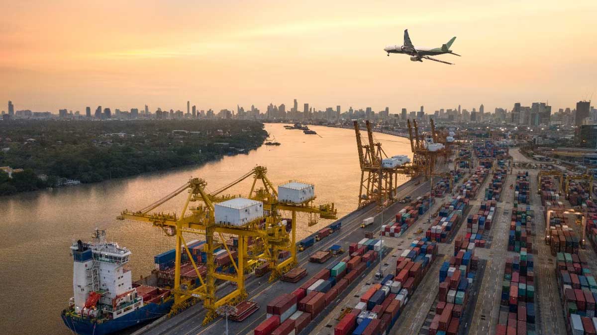 port on a river with an airplane flying over