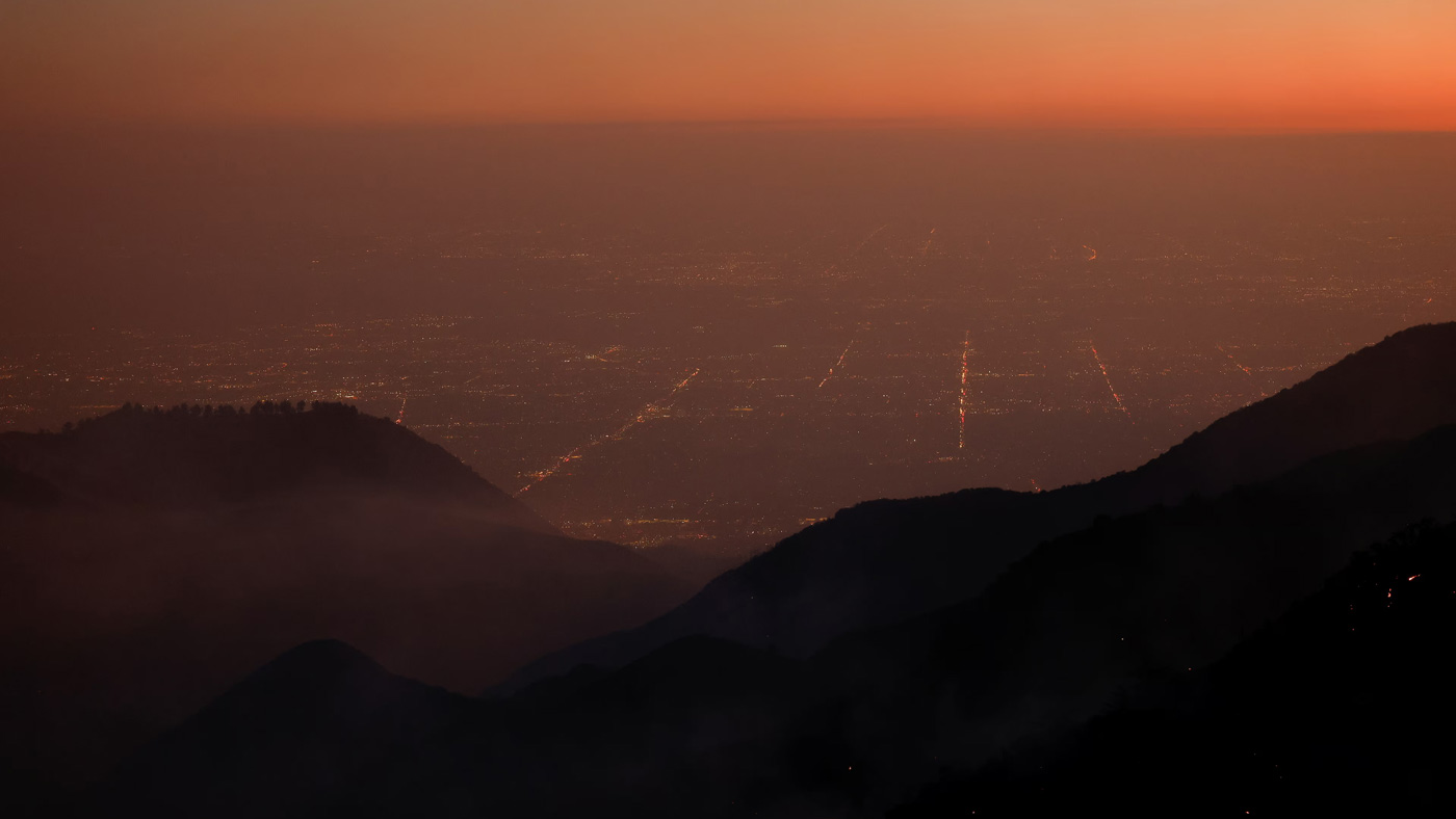 view mountains and a city at dusk from the sky